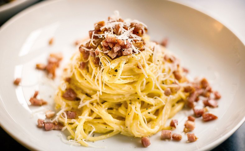 Carbonara topped with pancetta and parmesan